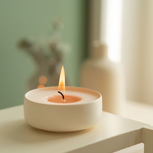 Warm candle flame symbolizing hope and community