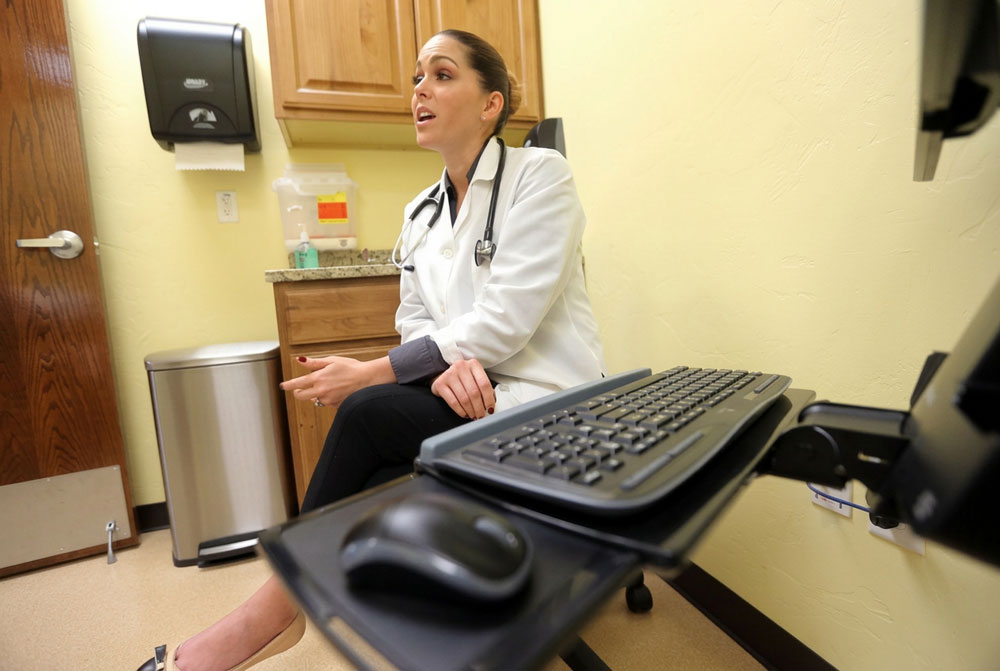 Primary care physician consulting with a patient at an on-site medical clinic